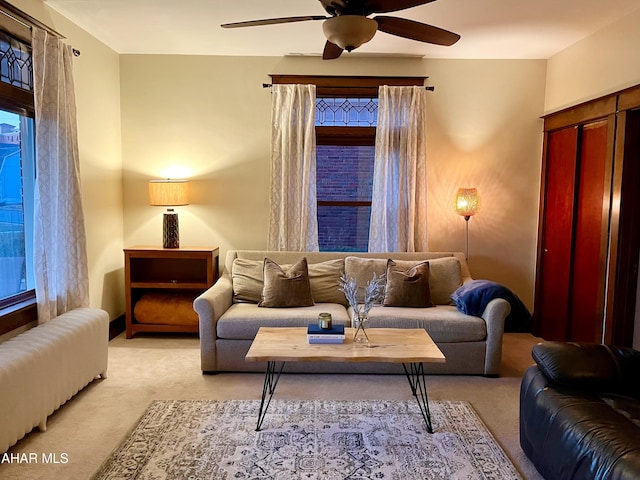 living room featuring light carpet and ceiling fan