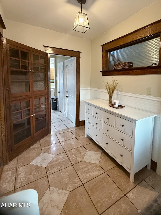 hallway featuring wainscoting