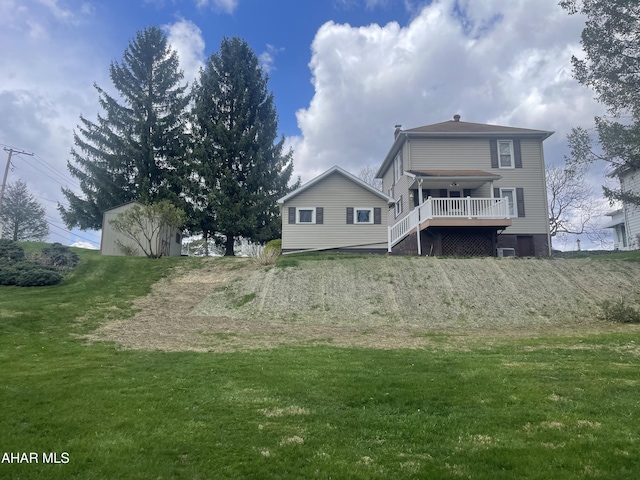 back of property featuring a yard and a deck