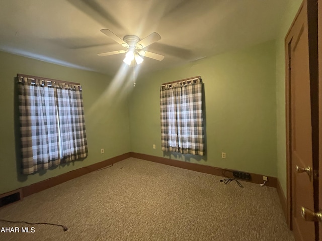 unfurnished bedroom featuring baseboards, a ceiling fan, and carpet flooring