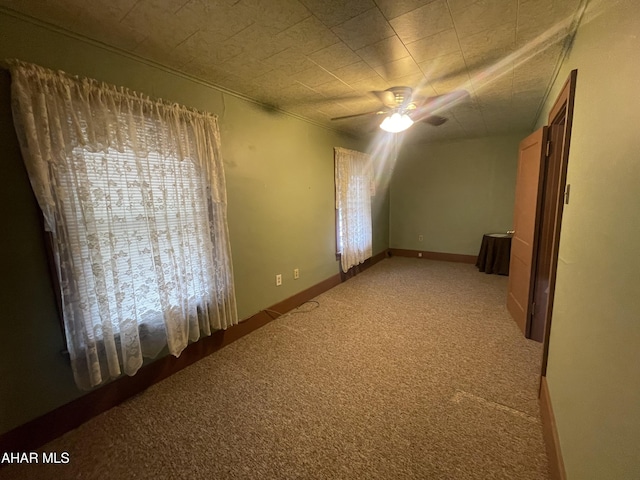 bonus room with carpet flooring and a ceiling fan