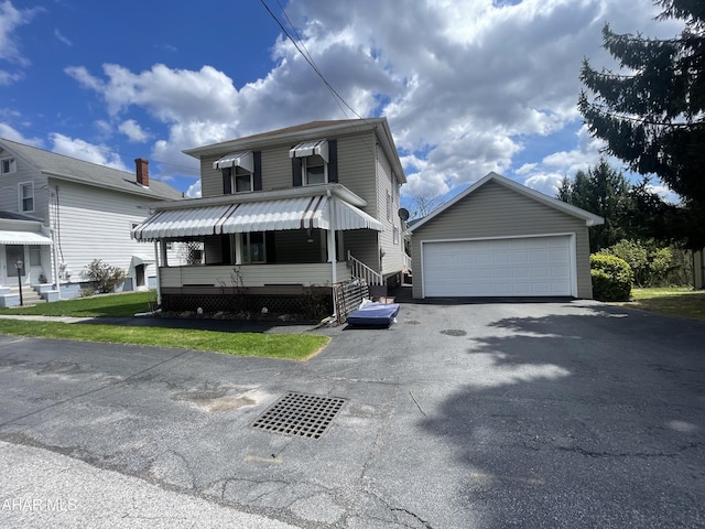 view of front facade featuring an outdoor structure and a garage
