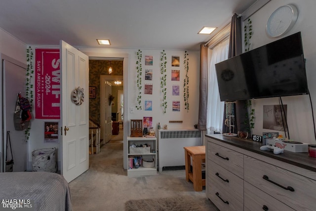 bedroom featuring radiator and light carpet