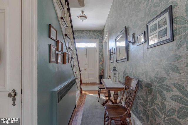 corridor featuring dark wood-type flooring and radiator heating unit