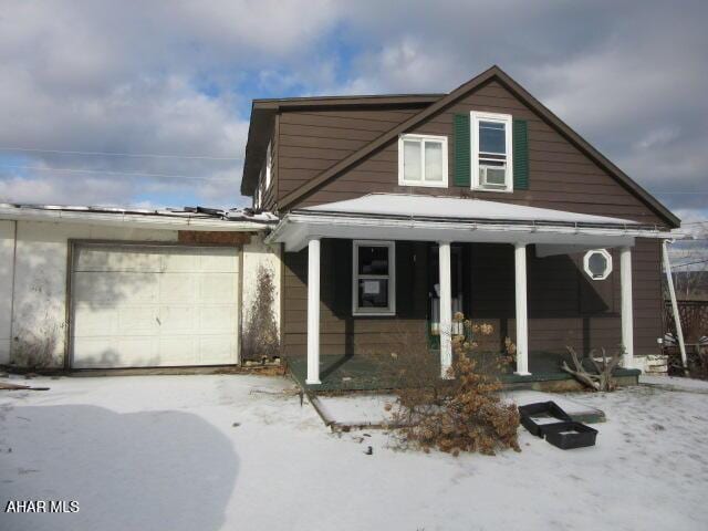 view of front of home featuring a porch and a garage