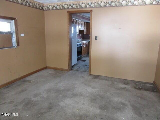 unfurnished room with concrete floors