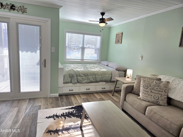 bedroom with ceiling fan, hardwood / wood-style floors, and ornamental molding