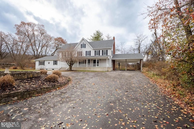 view of front of home featuring a carport and a porch