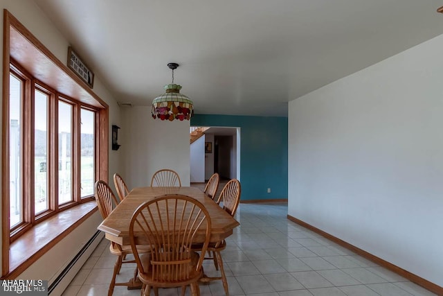 dining room with a baseboard heating unit and light tile patterned floors