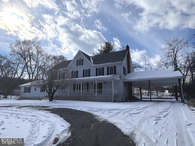 view of front of home featuring a carport and a porch