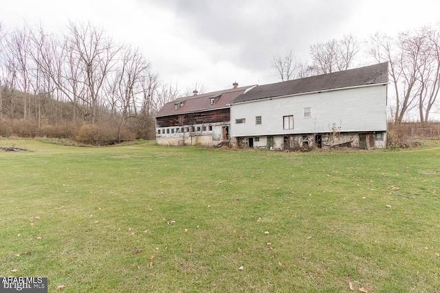 back of property featuring a yard