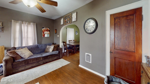 living room featuring dark hardwood / wood-style floors and ceiling fan