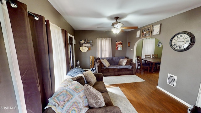 living room featuring hardwood / wood-style floors and ceiling fan