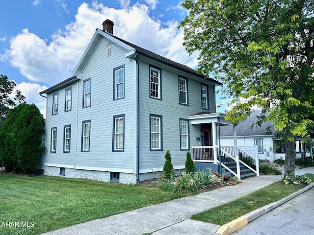 313 E John St, Bedford, PA 15522 - view of front of property with a chimney and a front lawn