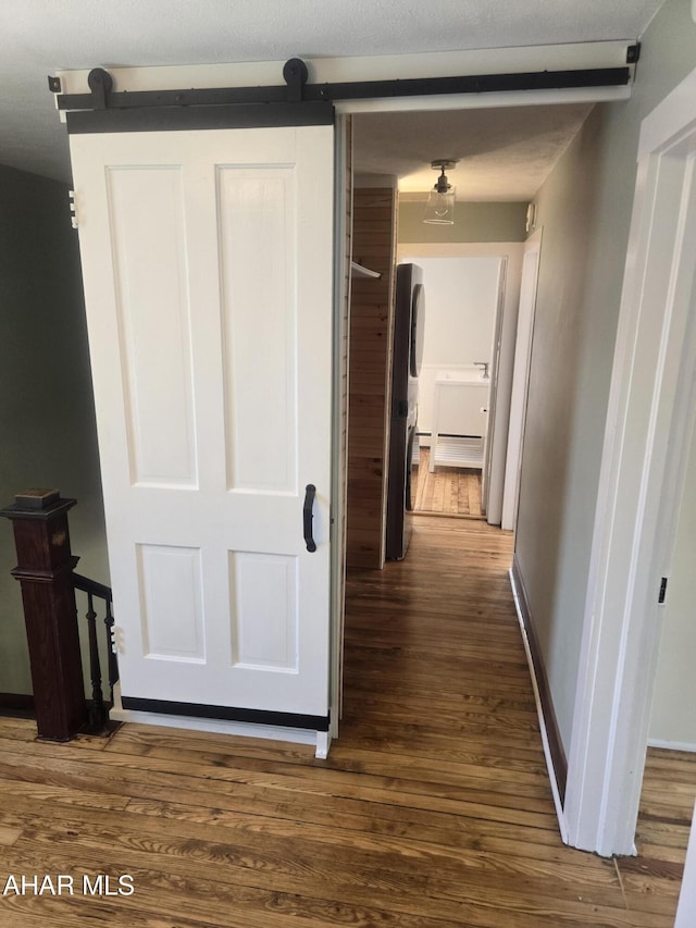313 E John St, Bedford, PA 15522 - hallway featuring a barn door and wood finished floors