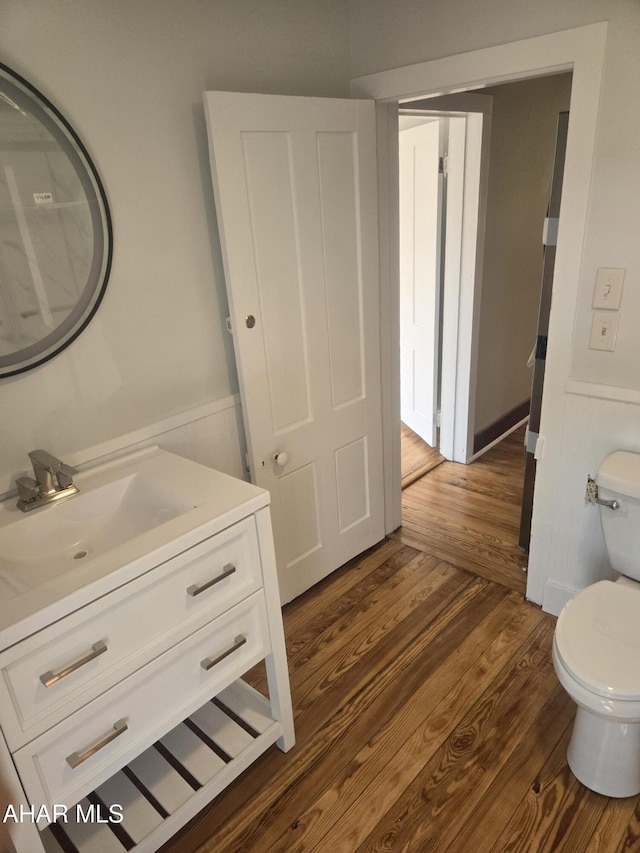313 E John St, Bedford, PA 15522 - bathroom with vanity, wainscoting, and wood finished floors