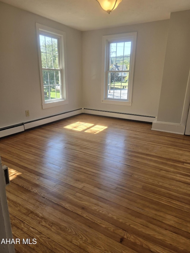 313 E John St, Bedford, PA 15522 - unfurnished room with plenty of natural light, dark wood-type flooring, and a baseboard radiator