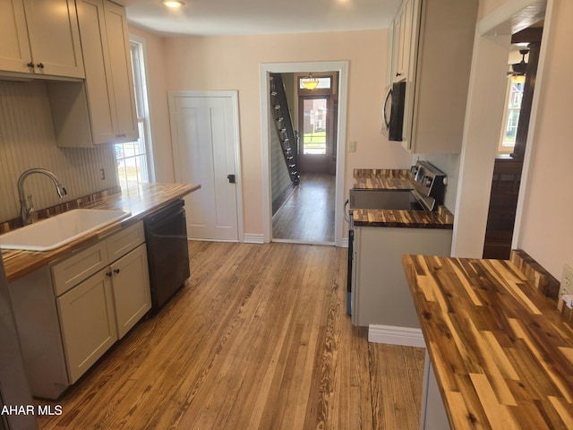313 E John St, Bedford, PA 15522 - kitchen featuring black appliances, wood finished floors, wooden counters, and tasteful backsplash