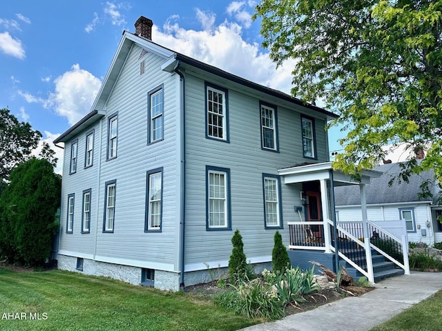 313 E John St, Bedford, PA 15522 - view of front facade featuring a chimney and a front lawn