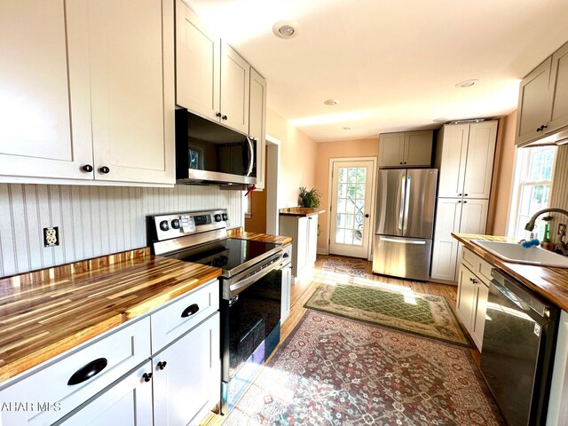 313 E John St, Bedford, PA 15522 - kitchen featuring appliances with stainless steel finishes, butcher block counters, and light wood-style floors