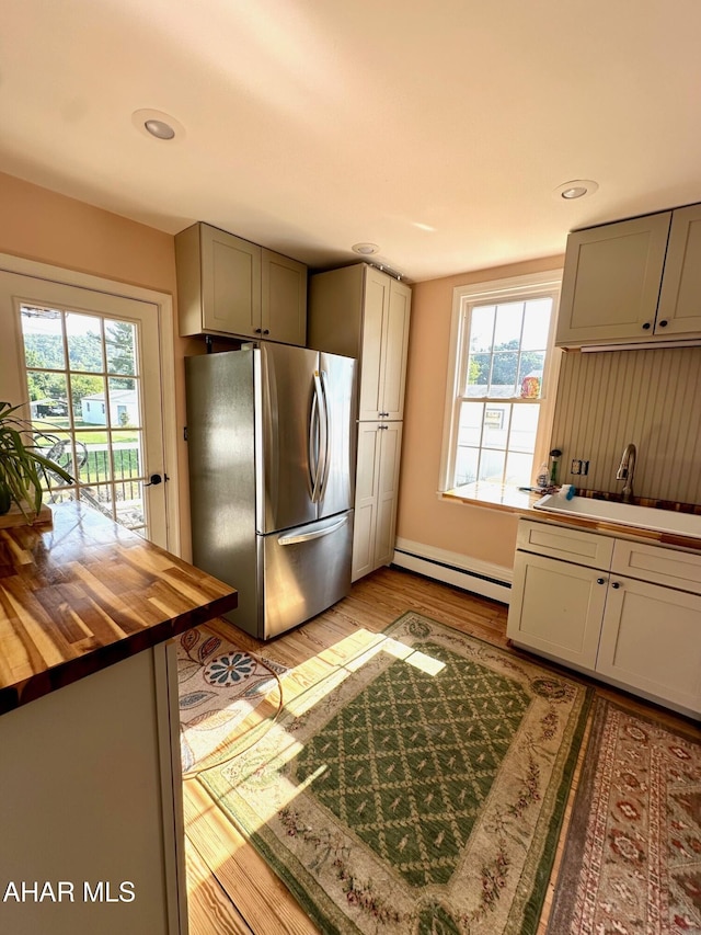 313 E John St, Bedford, PA 15522 - kitchen featuring freestanding refrigerator, butcher block counters, baseboard heating, healthy amount of natural light, and recessed lighting