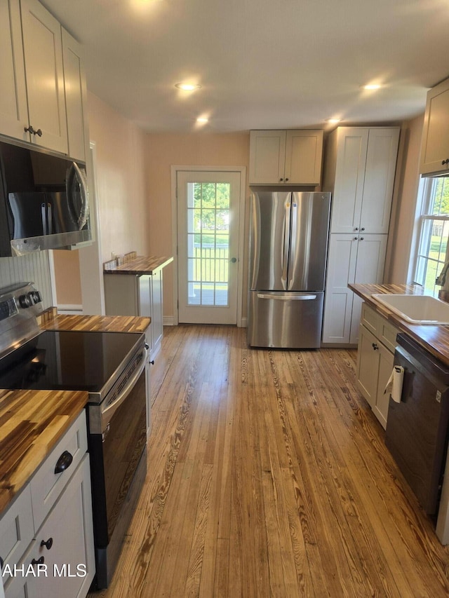 313 E John St, Bedford, PA 15522 - kitchen with stainless steel appliances, butcher block countertops, and wood finished floors
