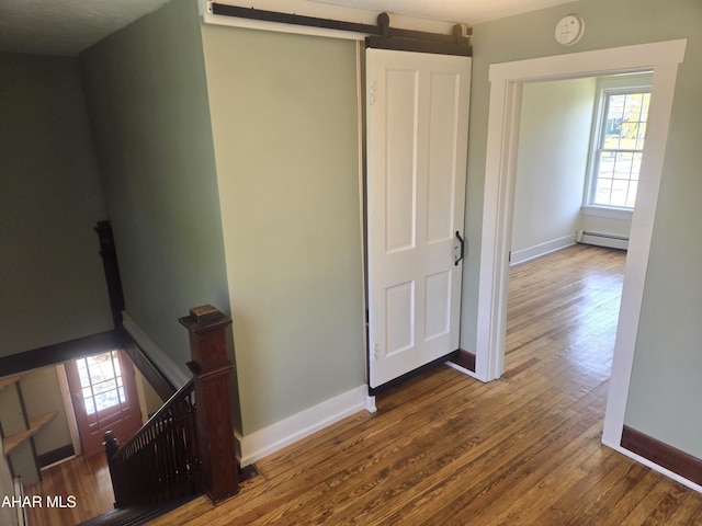 313 E John St, Bedford, PA 15522 - corridor with an upstairs landing, a baseboard radiator, wood finished floors, and healthy amount of natural light