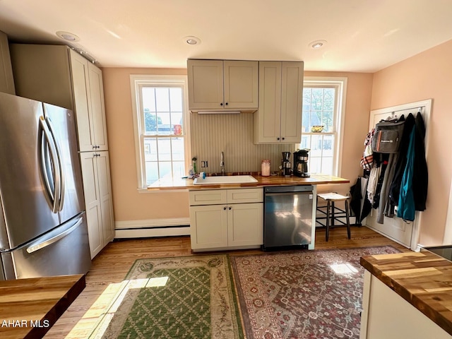313 E John St, Bedford, PA 15522 - kitchen featuring appliances with stainless steel finishes, wood counters, a baseboard radiator, wood finished floors, and recessed lighting