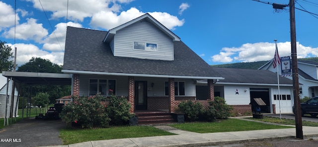 view of front of home featuring covered porch, concrete driveway, a carport, a garage, and brick siding