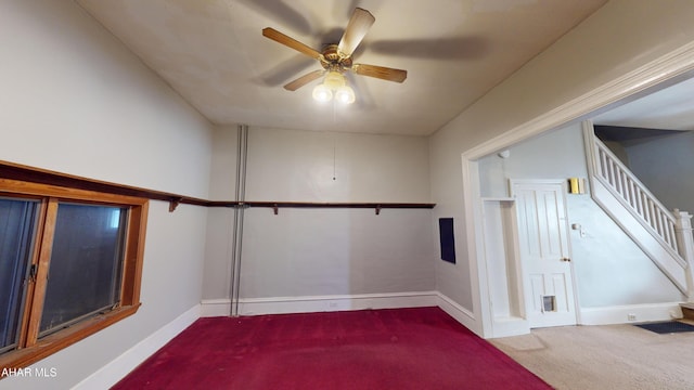 unfurnished room featuring ceiling fan and carpet floors