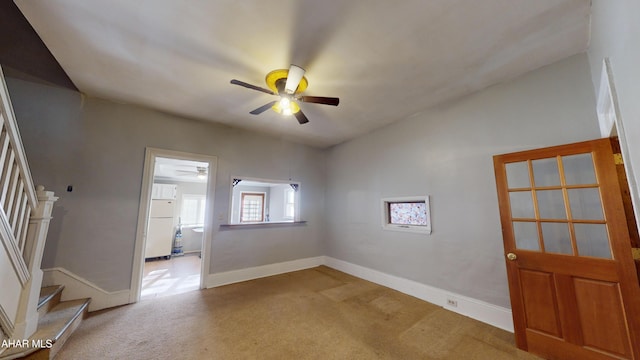 unfurnished room with ceiling fan, light colored carpet, and vaulted ceiling