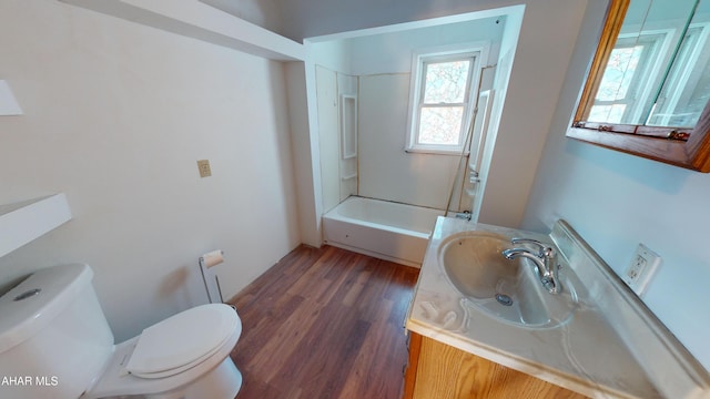 full bathroom with toilet, vanity, shower / bathtub combination, and hardwood / wood-style flooring