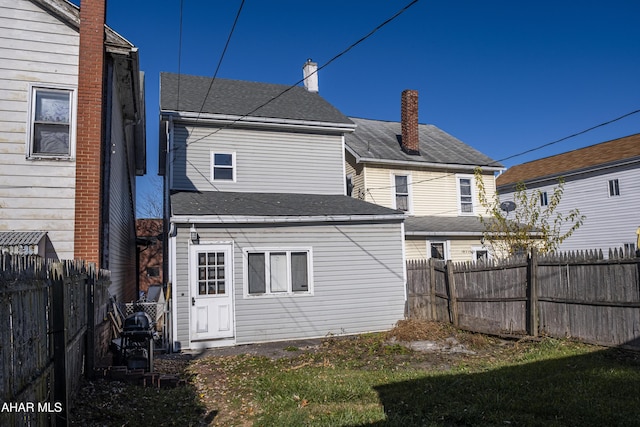 back of house with a yard