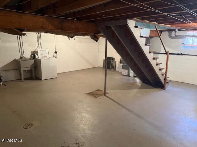 below grade area featuring stairs, independent washer and dryer, and a sink