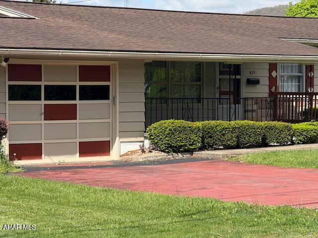 doorway to property with roof with shingles