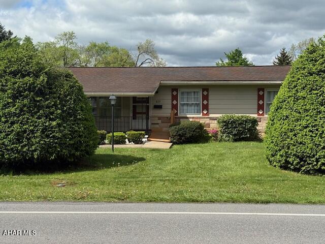 ranch-style house with a front lawn