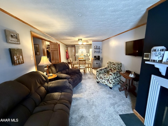 living area with carpet, a fireplace, crown molding, and a textured ceiling