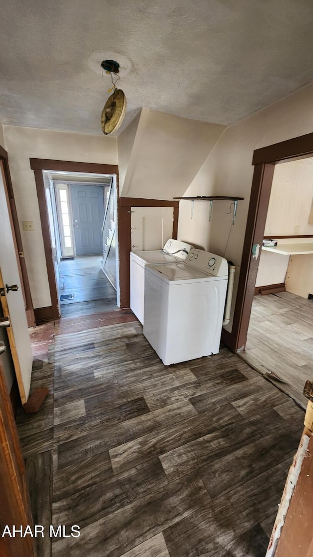 laundry room with dark hardwood / wood-style flooring and separate washer and dryer