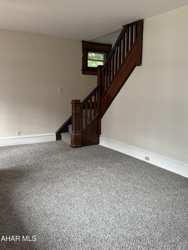 303 Cherry Ave, Altoona, PA 16601 - unfurnished living room with carpet flooring, stairs, and baseboards