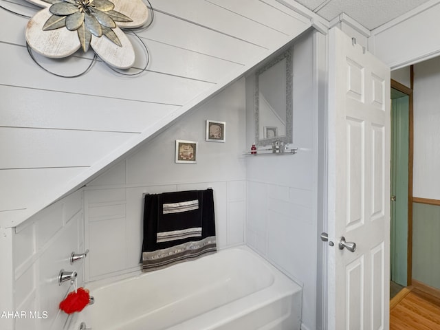 bathroom featuring a washtub and wood finished floors