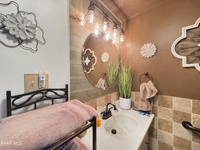 bathroom with a textured ceiling and vanity