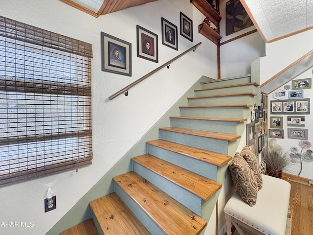 stairway featuring crown molding