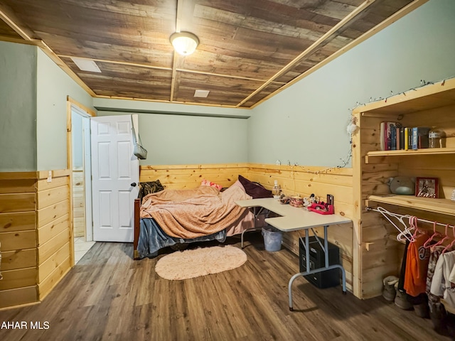 bedroom with wood ceiling, wood-type flooring, and wooden walls