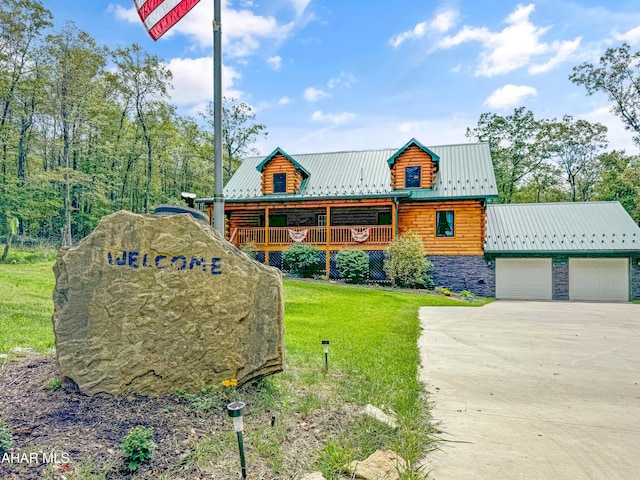 log cabin featuring a garage and a front yard