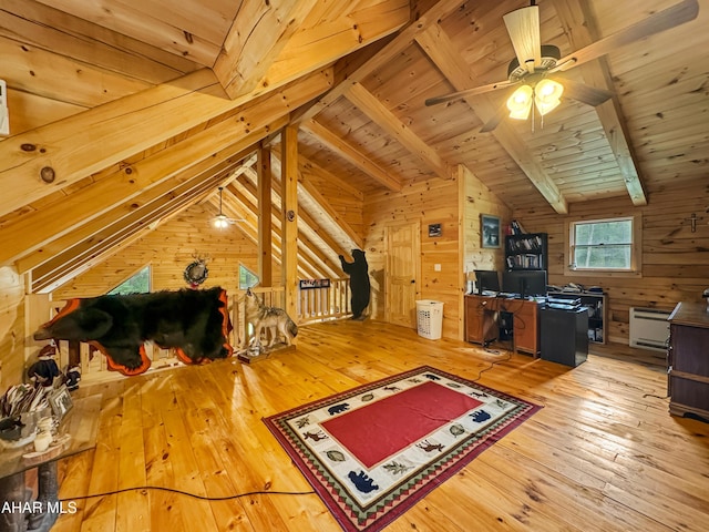 additional living space with wooden walls, vaulted ceiling with beams, hardwood / wood-style flooring, and wooden ceiling