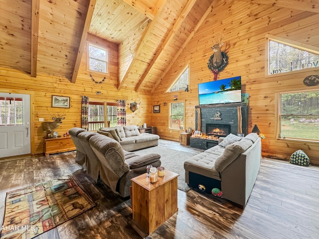 living room featuring high vaulted ceiling, dark hardwood / wood-style floors, wooden walls, and a wealth of natural light