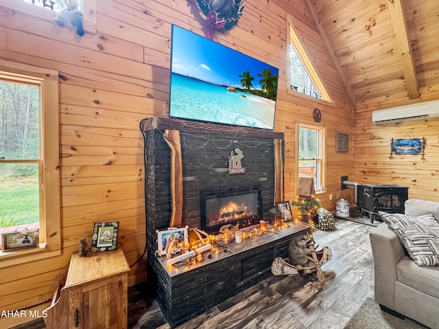 living room with beam ceiling, wooden ceiling, an AC wall unit, hardwood / wood-style floors, and wooden walls