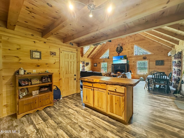 kitchen featuring vaulted ceiling with beams, wood ceiling, a center island, dark hardwood / wood-style floors, and wood walls