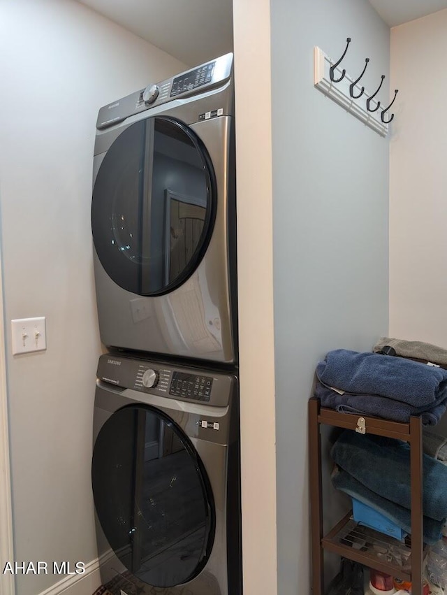 laundry area featuring stacked washer and clothes dryer