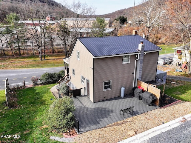 9802 Black Valley Rd, Everett, PA 15537 - view of property exterior featuring a lawn, a deck with mountain view, and a metal roof
